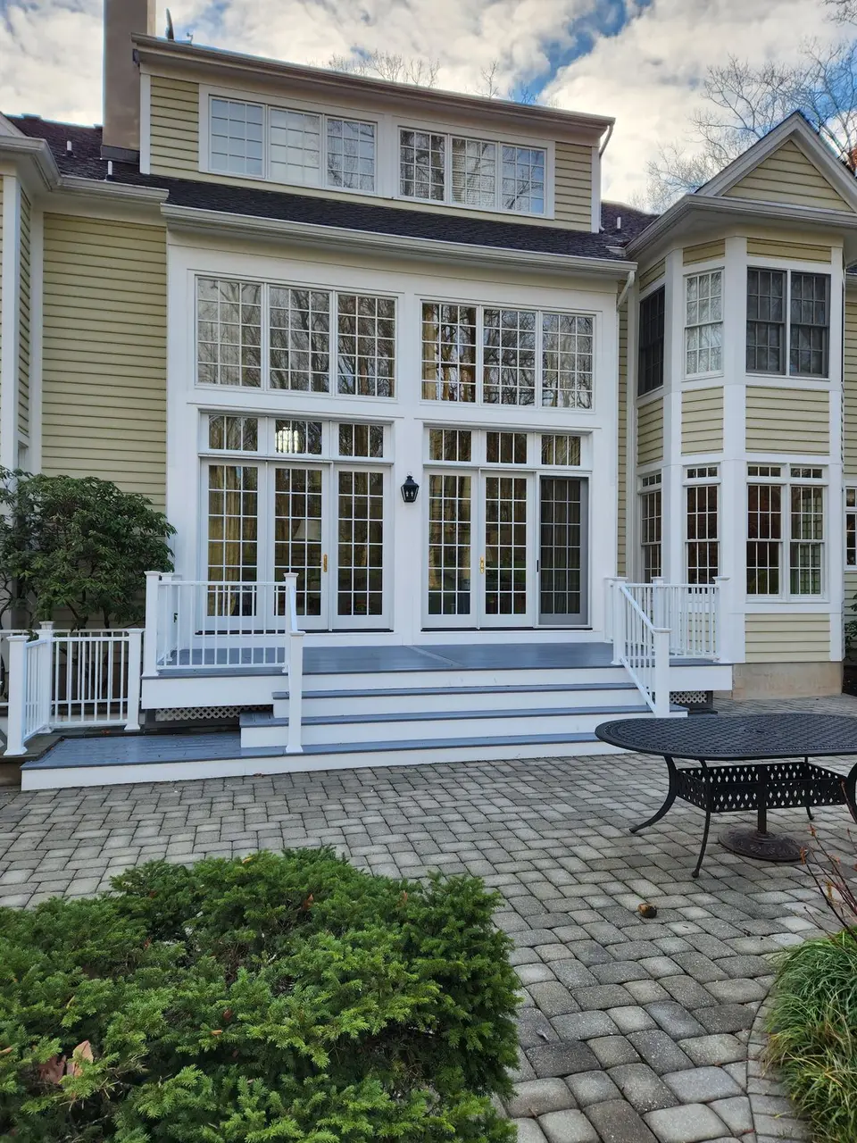 Rear addition with French doors, transom windows and a white porch
