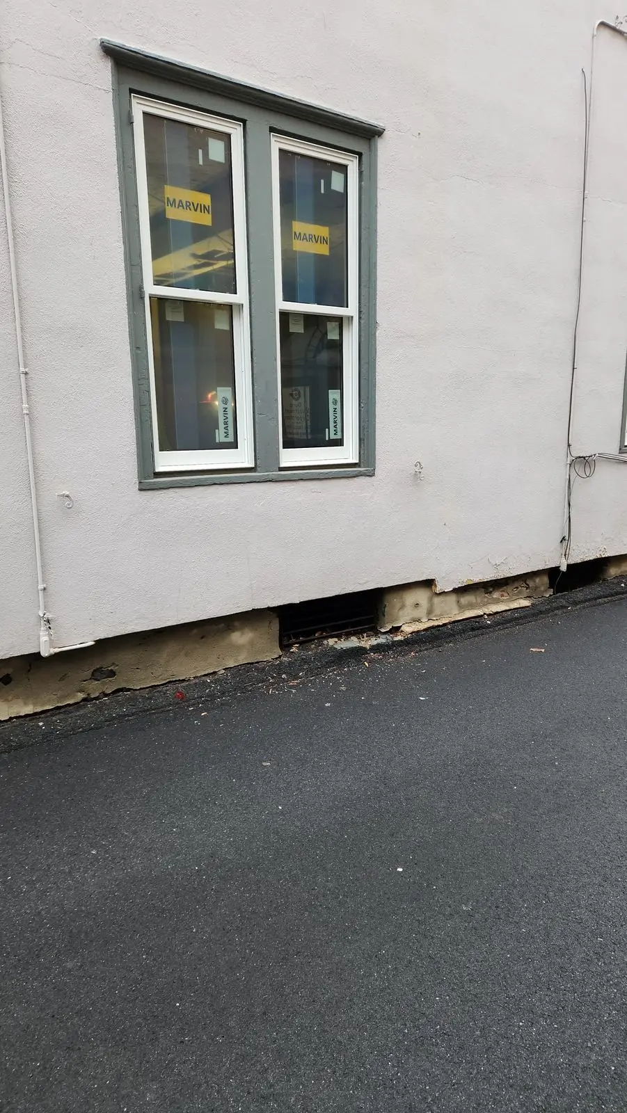 New double window set into a stucco wall, work in progress