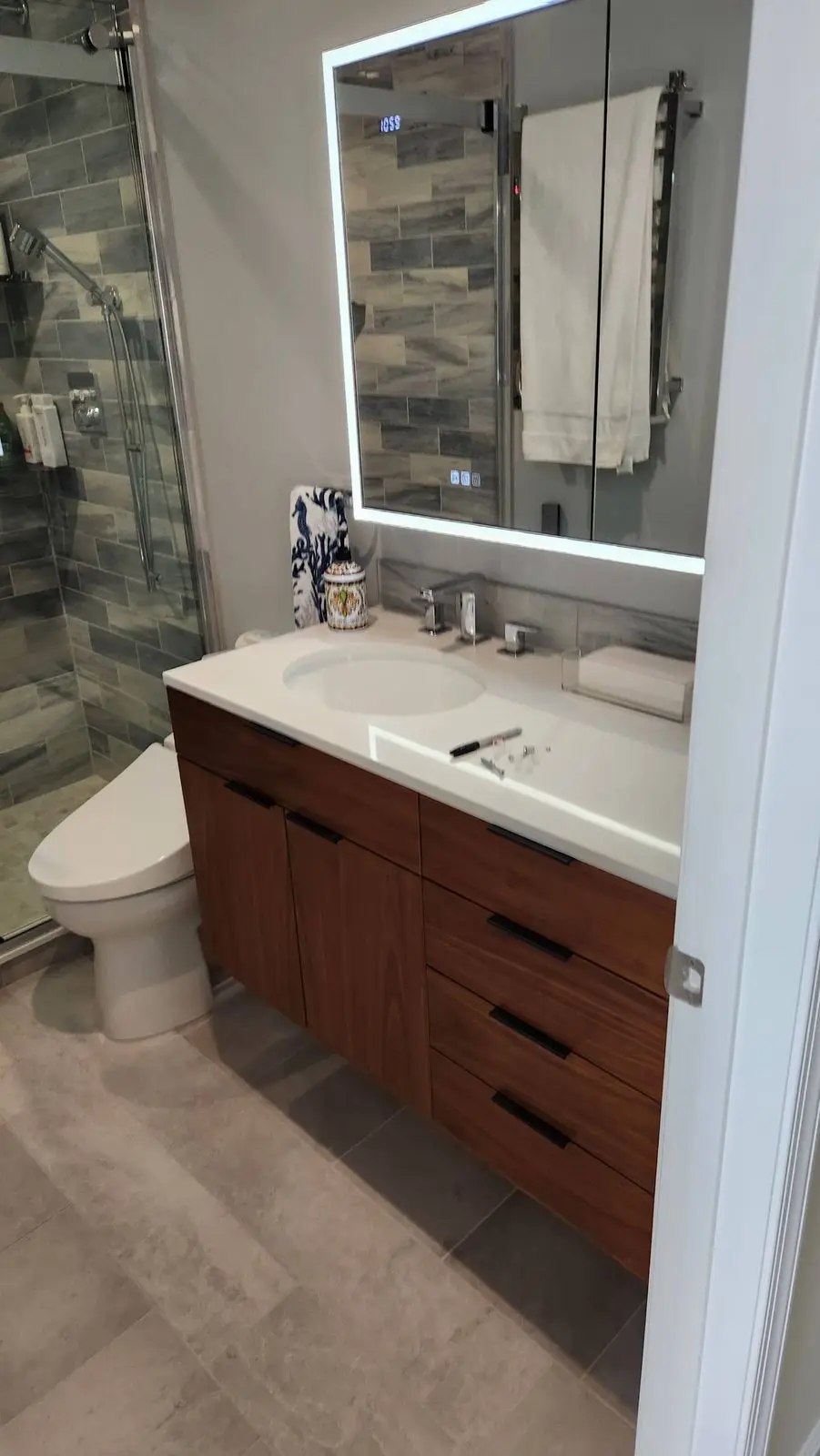 Walnut vanity with a lighted mirror